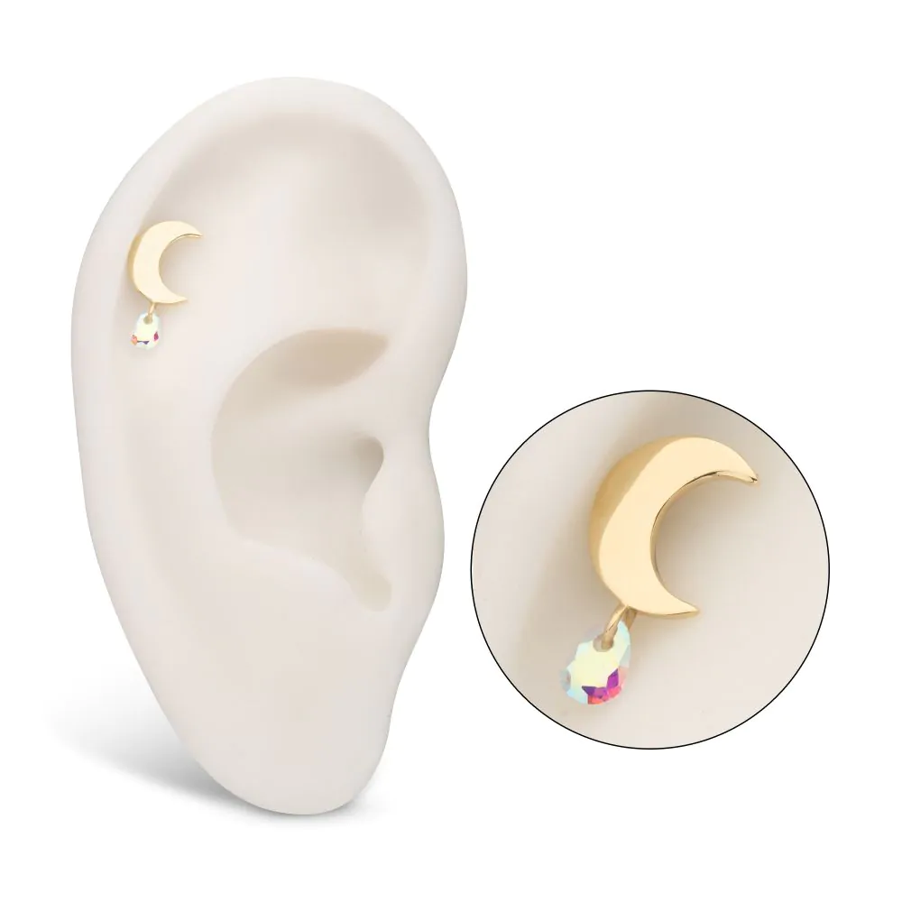 A 14k gold moon-shaped stud with a pear-shaped Swarovski dangle, displayed on a model ear.
