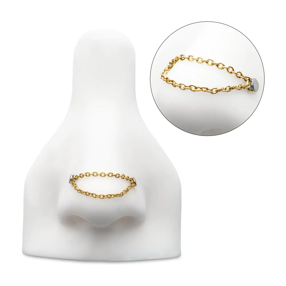 A rolo chain connector, pictured in a model nose, designed to connect two piercings or the front and back of the same piercing.