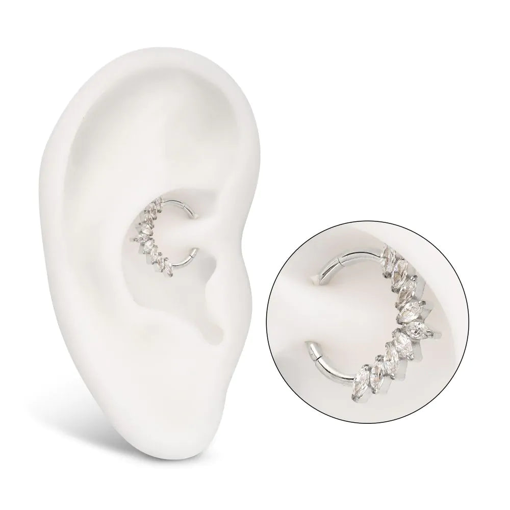 A 9-Gem Marquise Swarovski Clicker, featuring a titanium clicker with a series of round Swarovski gems attached to it, displayed in a model ear.