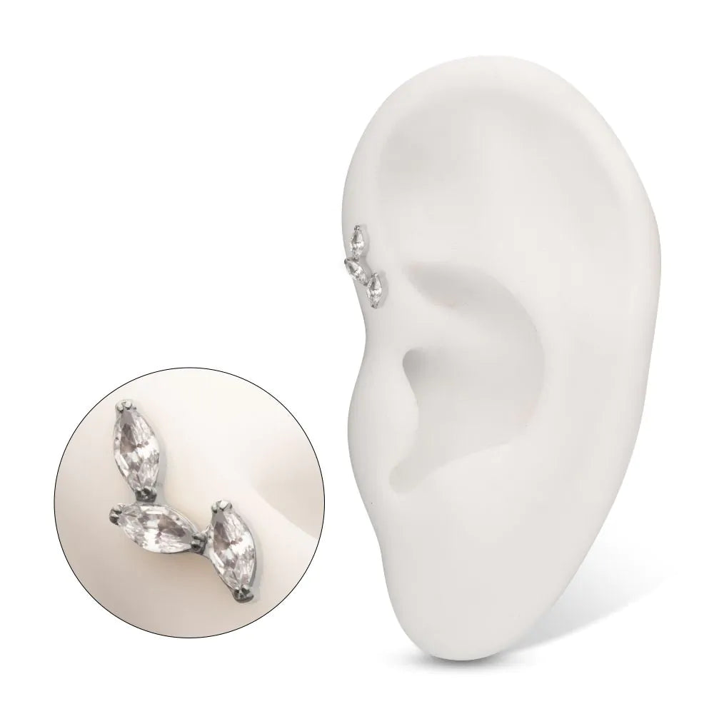 A stud earring with three marquise-shaped Swarovski crystals set in a prong-set design, displayed in a model ear, alongside a separate image of the jewelry that's close-up.