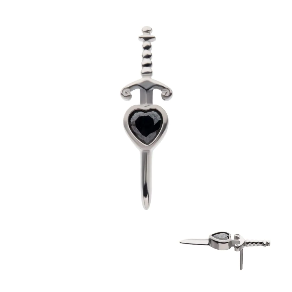 A close-up and a side shot of a titanium piece of jewelry, in the shape of a dagger piercing a black heart.